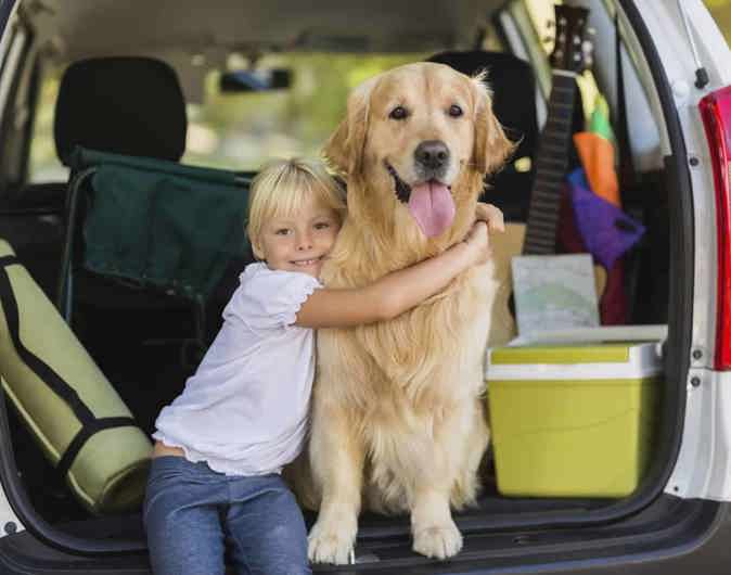 little girl hugging dog