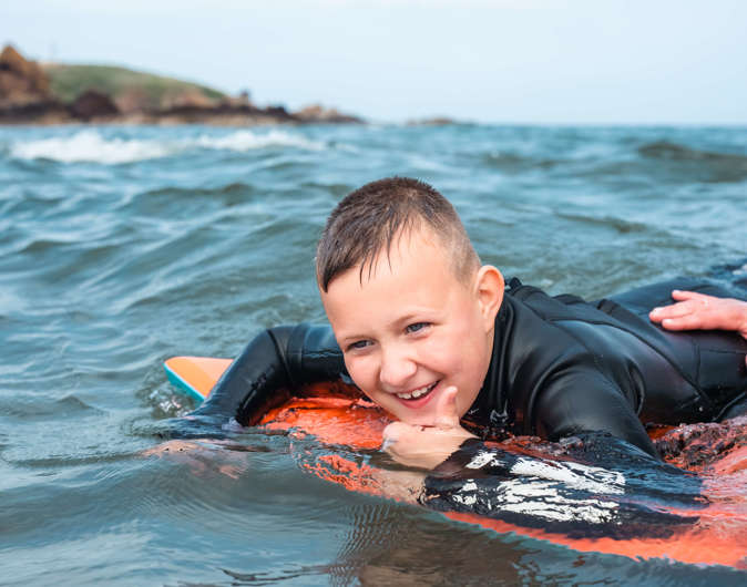 Body boarding at Coldingham Bay beach
