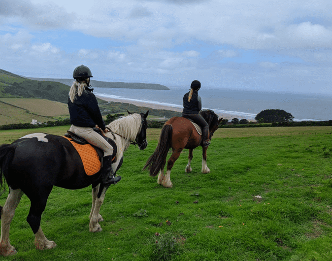 Riding horses over Woolacombe