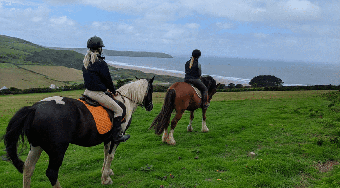 Riding horses over Woolacombe