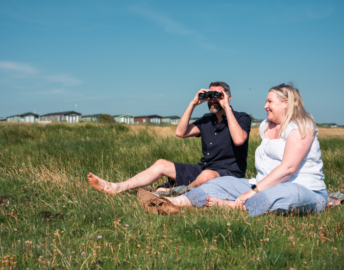 Couple watching wildlife at Queensberry Bay