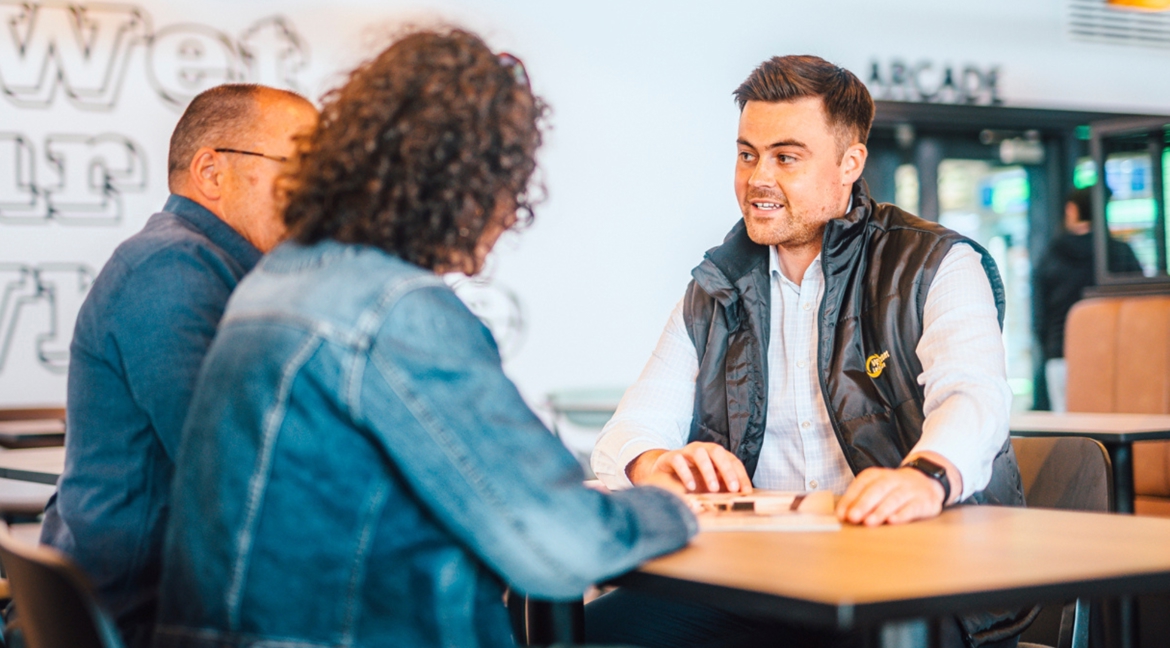 Couple chatting to salesman