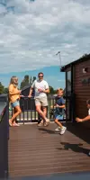 Family on lodge decking at Thurston Manor