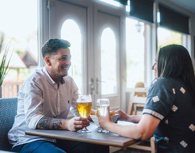 Couple enjoying a drink at Scoutscroft Leisure Park