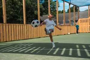Boy playing in multi use sports court