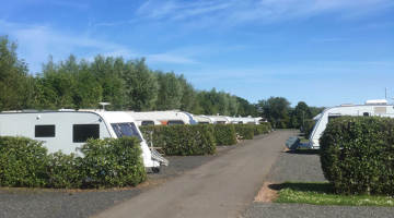 Touring vans and motorhomes at a UK holiday park 