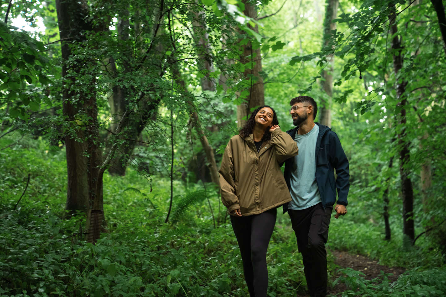 Couple walking in woodland