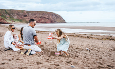 Children and family playing on the beach at Pease Bay