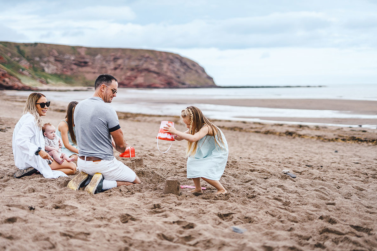 Children and family playing on the beach at Pease Bay