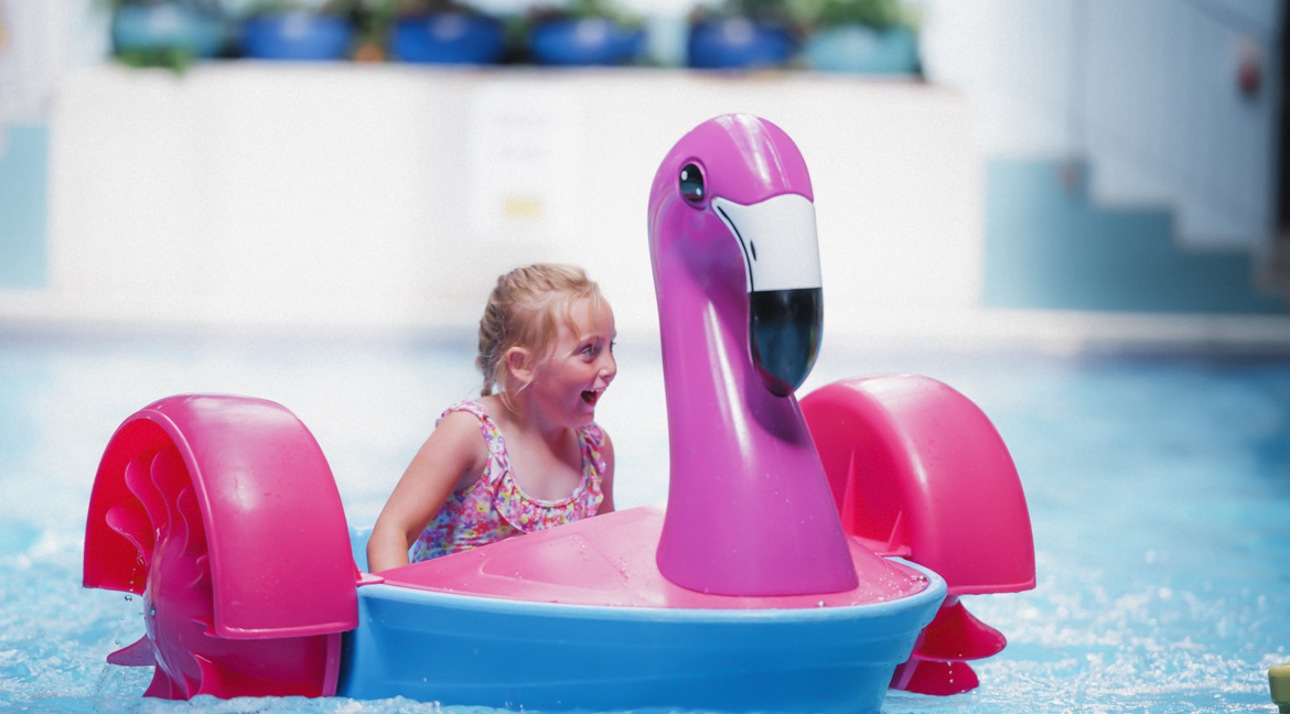 Girl on Swan paddler in pool