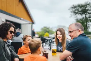 Family enjoying drinks on the terrace of The Drift Inn bar and restaurant 