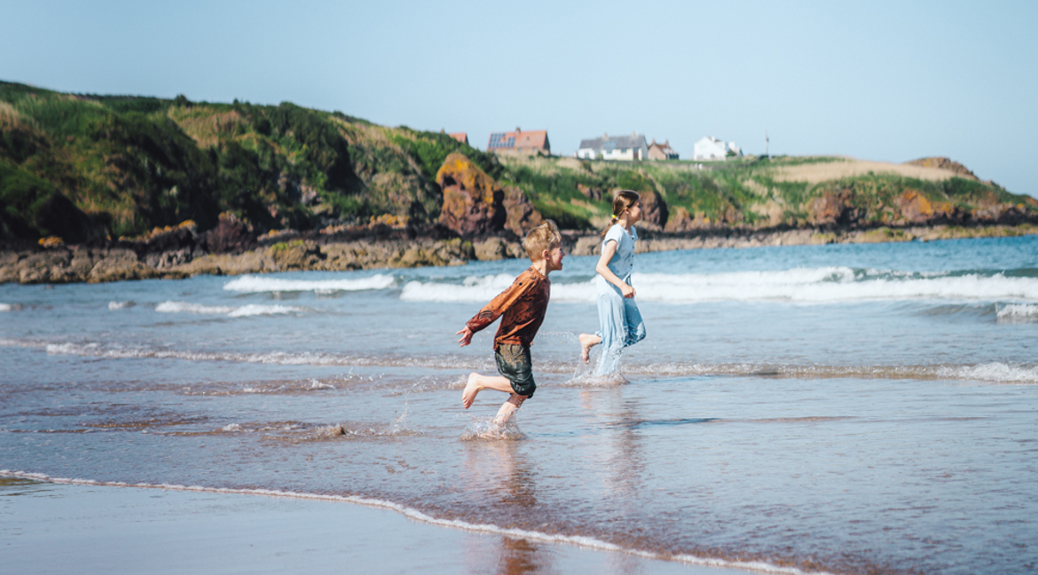 Children in the sea at Coldingham Beach near Scoutscroft