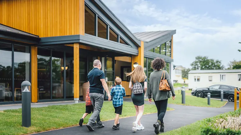 A family walking towards The Drift Inn bar and restaurant 