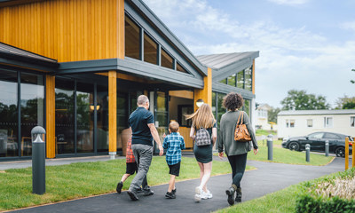 A family walking towards The Drift Inn bar and restaurant 