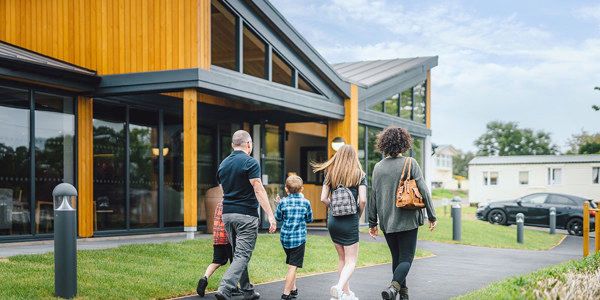 A family walking towards The Drift Inn bar and restaurant