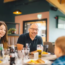 A family enjoying food and drinks indoors at The Drift Inn bar and restaurant 