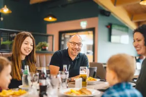 A family enjoying food and drinks indoors at The Drift Inn bar and restaurant 